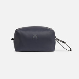 A studio shot of the logo on the side of a Wash Bag in Midnight Blue