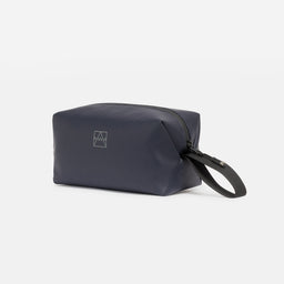 A studio shot of the side and grab handle of a Midnight Blue Wash Bag