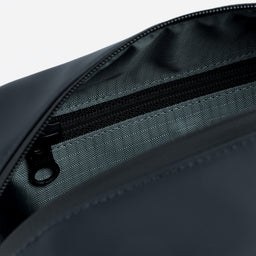 A studio shot of the interior pockets and blue lining in a Midnight Blue Wash Bag