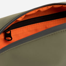 A studio shot of the inside of the Urban Green Wash bag with orange lining