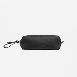 A studio shot of the back of the Wash Bag Mini in All Black showing the logo