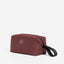 A studio shot of the wash bag in garnet red- shop all
