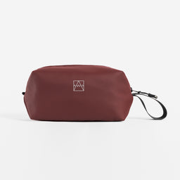 A studio shot of the side and reflective logo on the Garnet Red Wash Bag