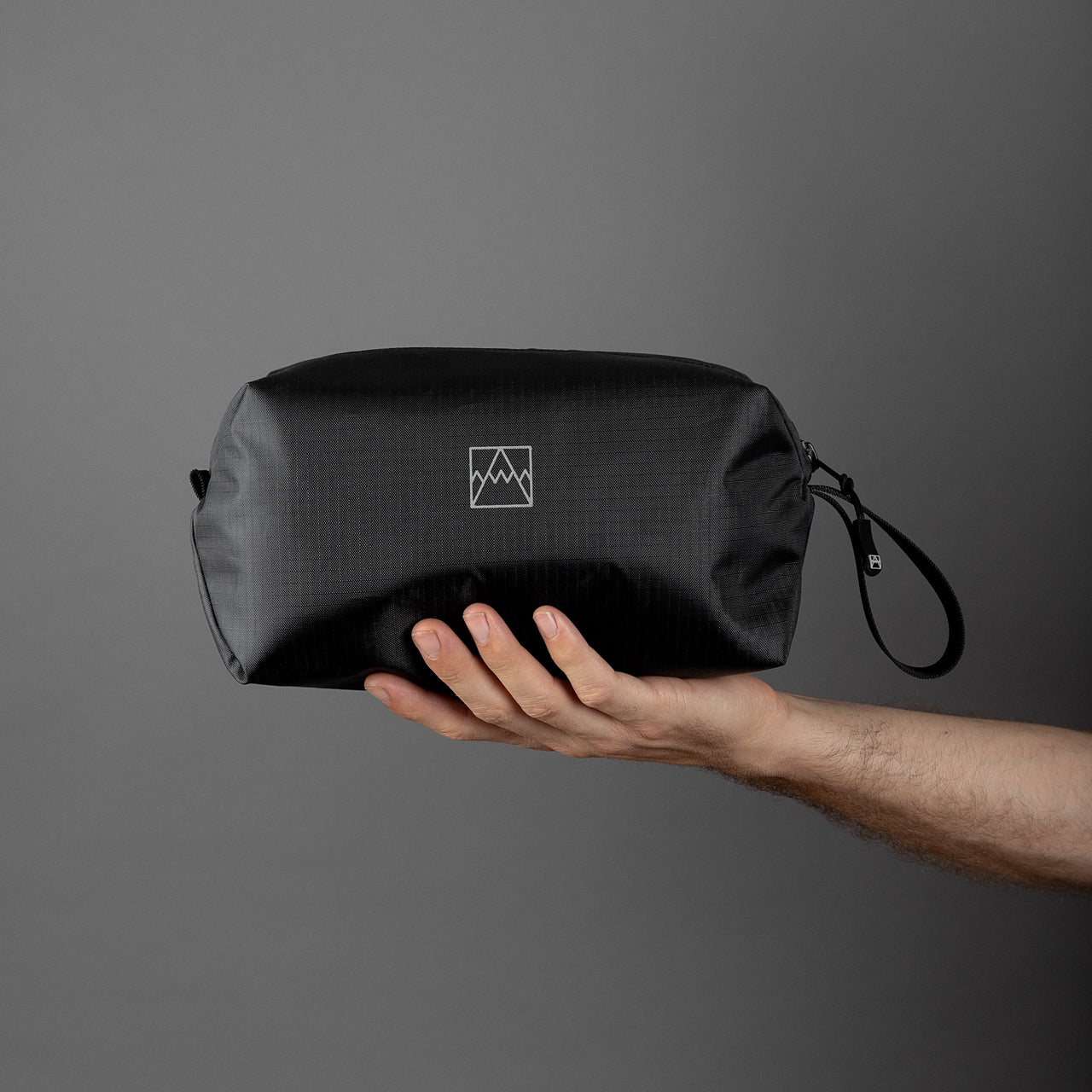 Wash Bag in rPET held in a hand