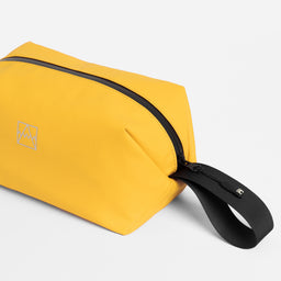 Close-up of the grab handle on the Wash Bag in Yellow