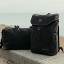 The Weekender duffle bag in All Black and backpack
