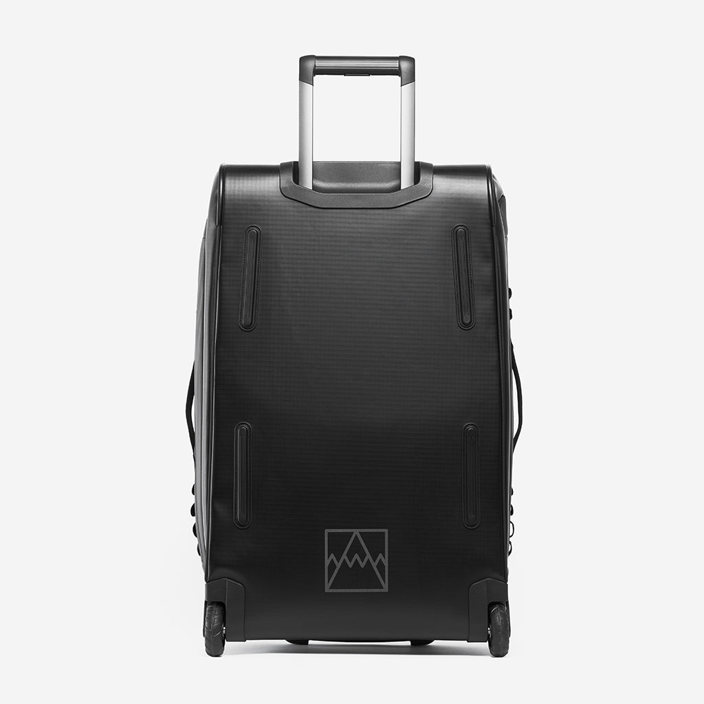 A studio shot of the Wheeled Kit Bag 80L in All Black showing the back and reflective branding