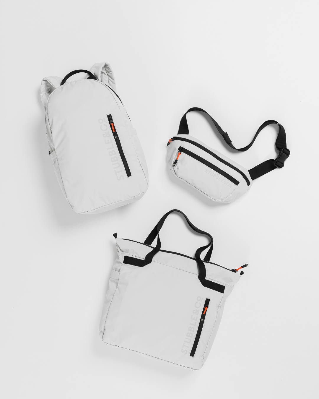 Packable Backpack, Packable Sling and Packable Tote in Off-White laid out on a white background. 