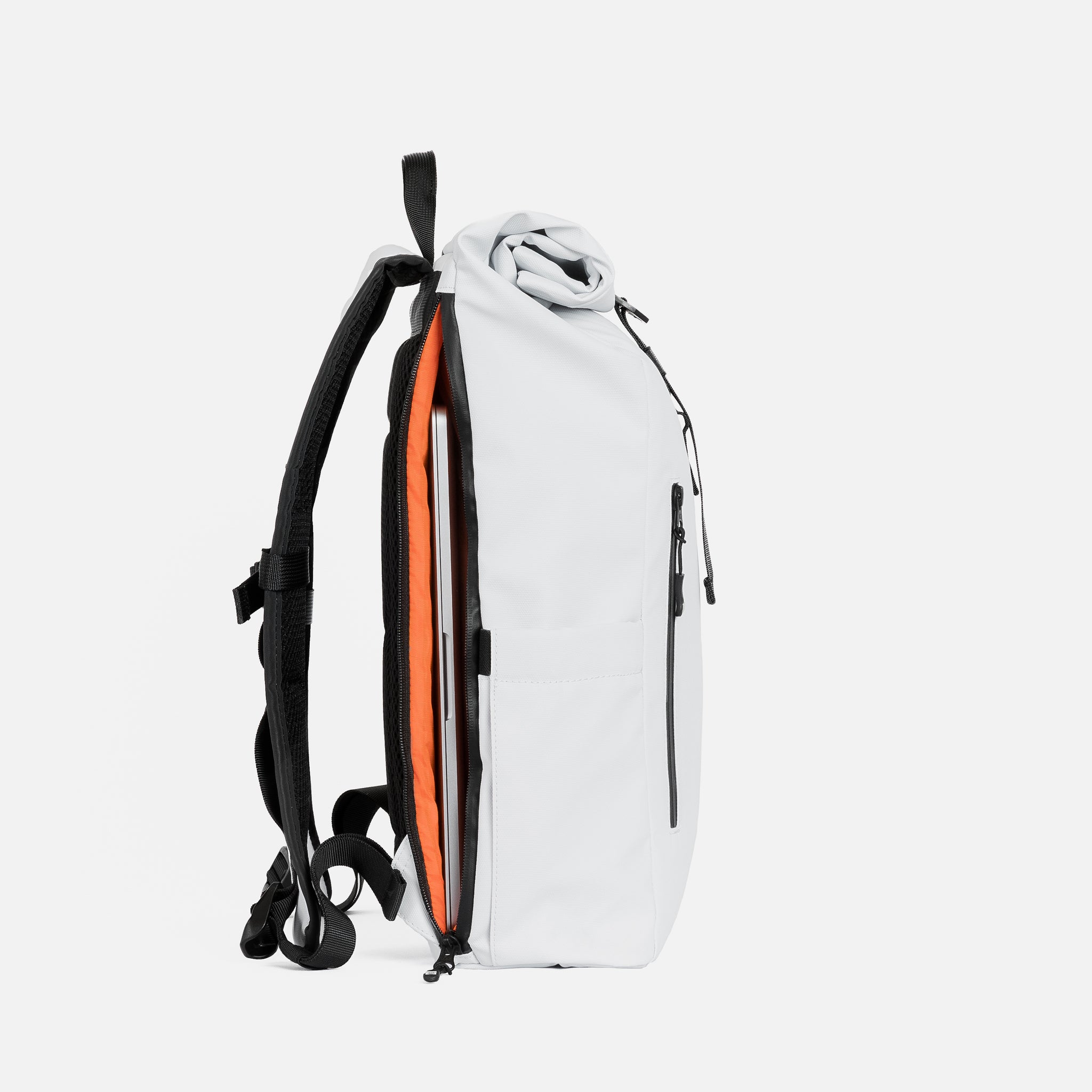 The side profile of the Roll Top Mini and its laptop compartment backpack in Arctic White