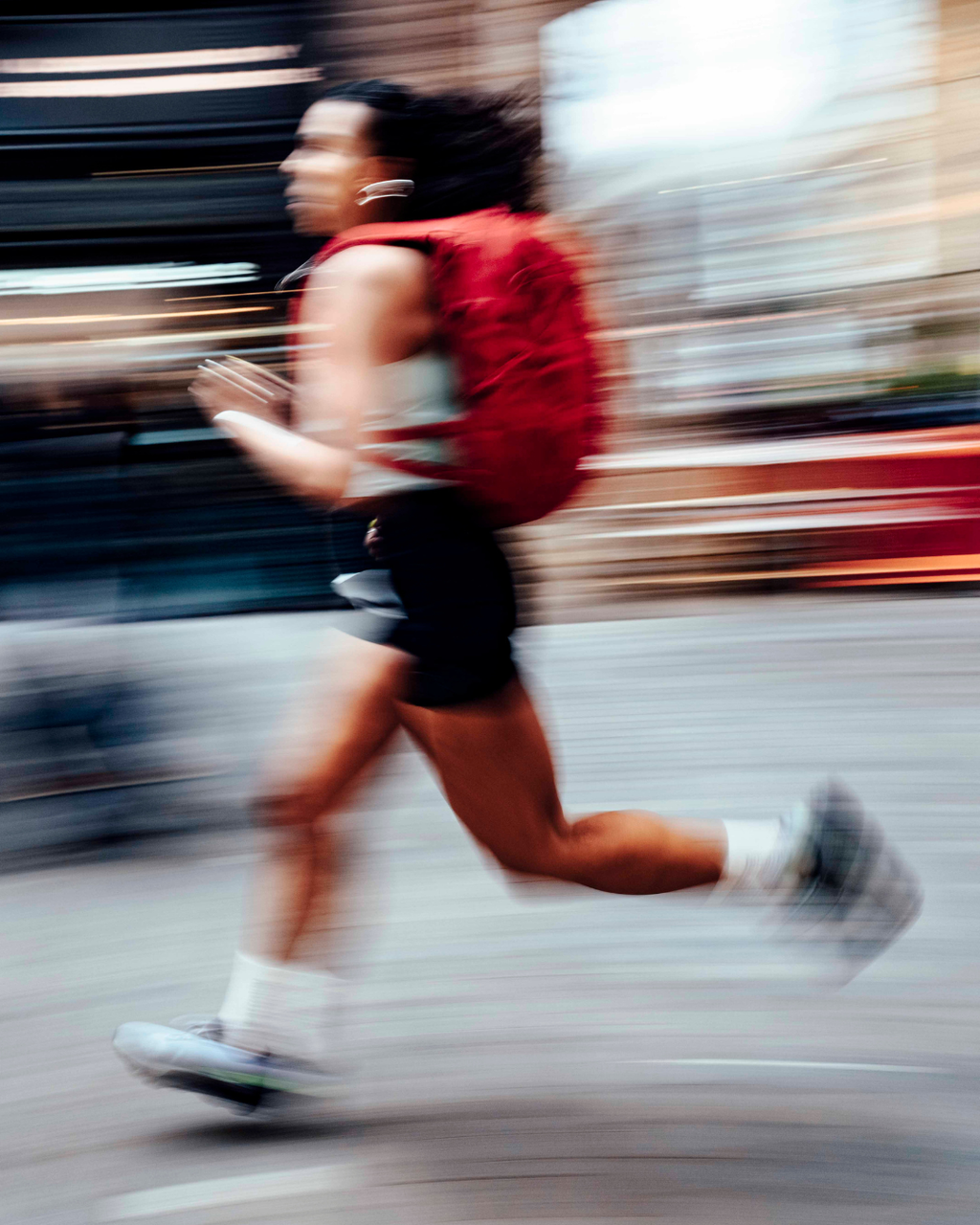 A blurry photo of a woman wearing a magma motion backpack 20l