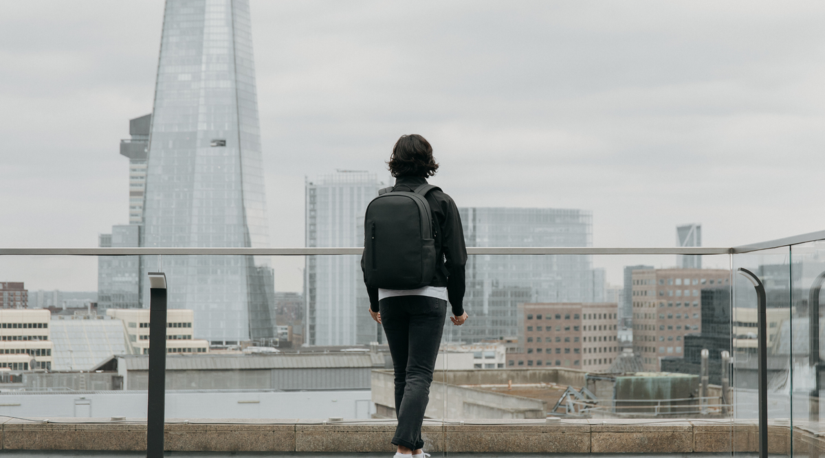 Person wearing the Everyday Backpack 20L in All Black, overlooking London with the Shard in view.