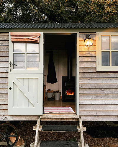 A wood cabin in a field