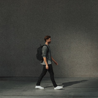 Side view of a man wearing the Commuter in All Black while walking.
