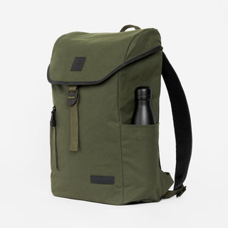 Backpack in Olive shot from the side with a black water bottle in the side pocket.