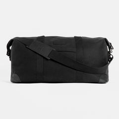 Product shot of The Weekender in All Black from the front, with the shoulder strap in front.